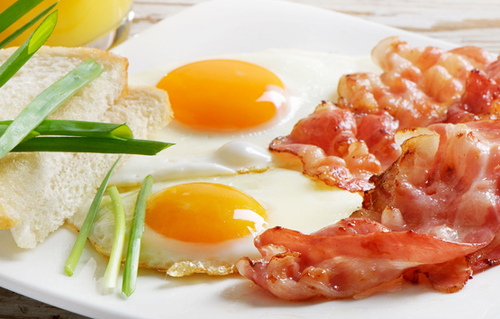 Traditional breakfast with bacon and fried eggs